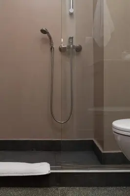a shower stall in a bathroom with a toilet at Absolute Athens VII in Athens
