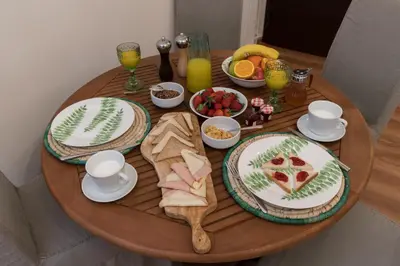 a wooden table with plates of food on it at Absolute Athens VII in Athens