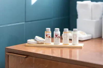three bottles of essential oils sitting on a cutting board at Hidesign Athens Apollon Luxury Apt in Plaka Acropolis in Athens