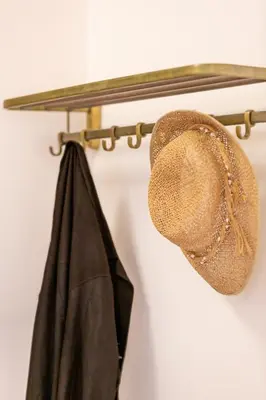a hat and a coat hanging on a rack at Hidesign Athens Apollon Luxury Apt in Plaka Acropolis in Athens