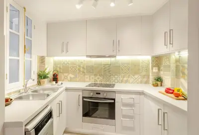 a white kitchen with white cabinets and a sink at Hidesign Athens Apollon Luxury Apt in Plaka Acropolis in Athens