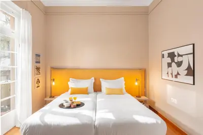 a bedroom with a large white bed with yellow pillows at Hidesign Athens Apollon Luxury Apt in Plaka Acropolis in Athens