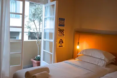 a bedroom with a bed and a window at Hidesign Athens Apollon Luxury Apt in Plaka Acropolis in Athens