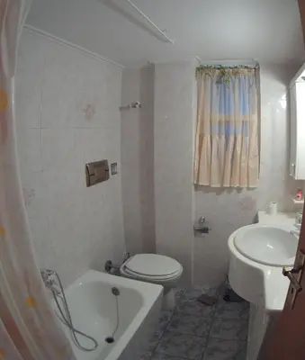a small bathroom with a toilet and a sink at BLUE & WHITE MAISONETTE OVER THE SEA NEAR SOUNIO in Sounio
