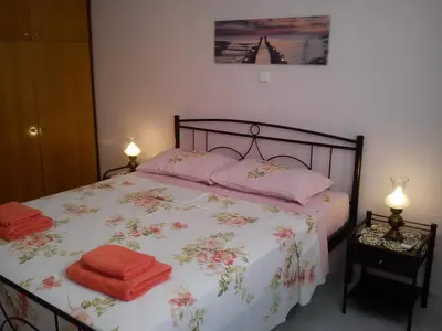 a bedroom with a bed with two towels on it at BLUE & WHITE MAISONETTE OVER THE SEA NEAR SOUNIO in Sounio