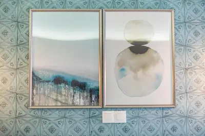 two framed pictures hanging on a wall at Plaka Akrokeramo House #1 in Athens