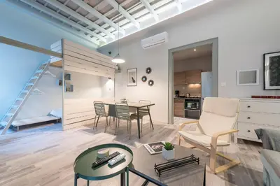 a living room with a couch and a table at Plaka Akrokeramo House #1 in Athens