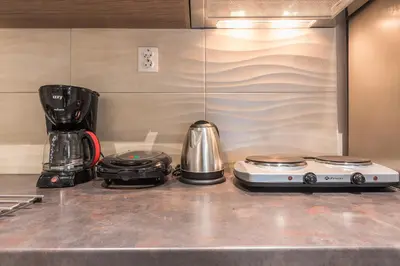 a kitchen counter with a blender and a coffee maker at Plaka Akrokeramo House #1 in Athens