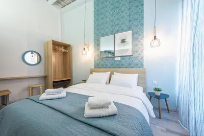 a bedroom with a large bed with towels on it at Plaka Akrokeramo House #1 in Athens