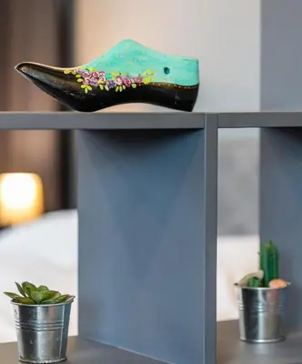 a shoe sitting on top of a shelf with plants at Boutique Apartment in Athens Center in Athens
