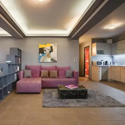 a living room with a purple couch and a table at Boutique Apartment in Athens Center in Athens