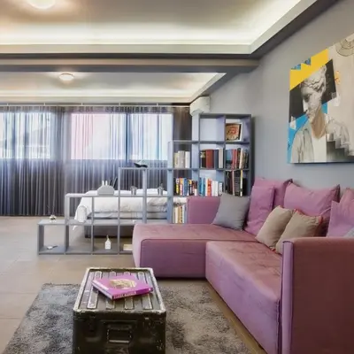 a living room with a purple couch and a table at Boutique Apartment in Athens Center in Athens