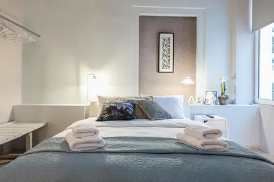 a bedroom with a bed with towels on it at Plaka Akrokeramo House #2 in Athens
