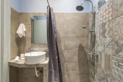 a bathroom with a sink and a shower at Plaka Akrokeramo House #2 in Athens