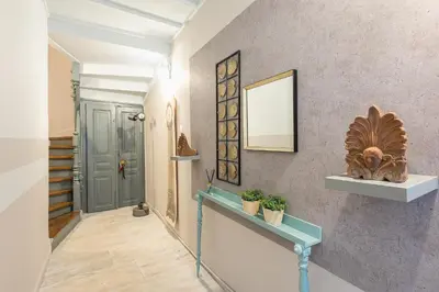 a hallway with a blue door and some plants at Plaka Akrokeramo House #2 in Athens