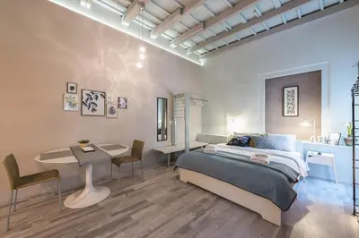 a bedroom with a bed and a table and chairs at Plaka Akrokeramo House #2 in Athens