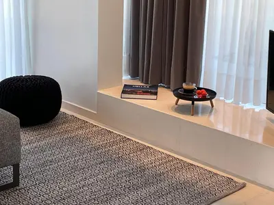 a living room with a table in front of a window at Brasil Suites Boutique Hotel in Athens