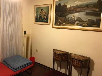 a room with two chairs and a painting on the wall at Luxury apartment close to city center, university and children's hospital in Athens