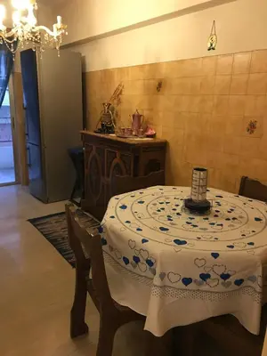 a dining room with a table with a white and blue table cloth at Luxury apartment close to city center, university and children's hospital in Athens