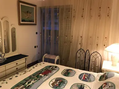 a bedroom with a bed and a table and chairs at Luxury apartment close to city center, university and children's hospital in Athens
