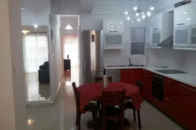 a kitchen with a table with a red table cloth on it at Ani's apartments in Athens