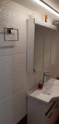 a bathroom with a sink and a mirror and a shower at Ani's apartments in Athens