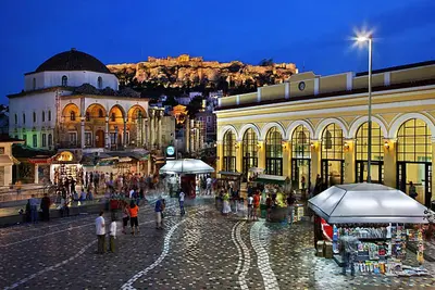 a group of people walking around a street with a building at Ani's apartments in Athens