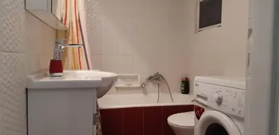 a bathroom with a sink and a toilet and a tub at Ani's apartments in Athens