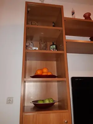 a shelf with a bowl of fruit in a kitchen at Ani's apartments in Athens