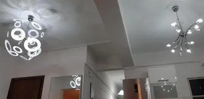 a kitchen with a ceiling with a chandelier on it at Ani's apartments in Athens