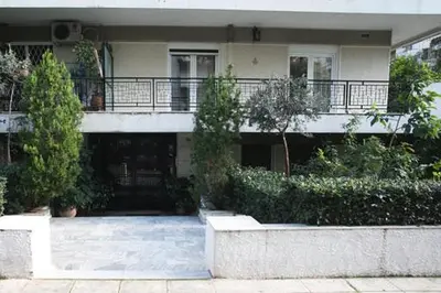 a house with a porch and a balcony at Athenian Riviera Apartment in Athens