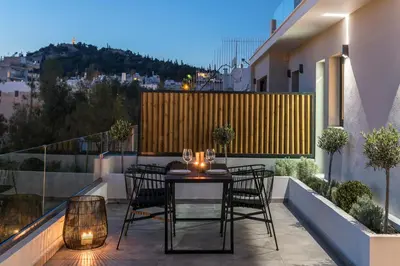 a patio with a table and chairs on a balcony at Hub Suites, Luxury living in Athens in Athens