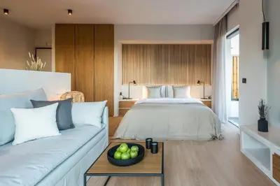 a bedroom with a bed and a bowl of fruit on a table at Hub Suites, Luxury living in Athens in Athens