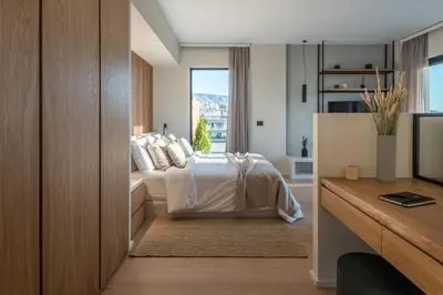 a bedroom with a bed and a window at Hub Suites, Luxury living in Athens in Athens