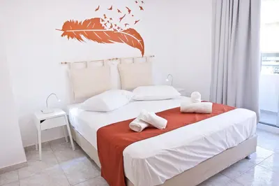 a bedroom with a bed with two towels on it at SilkFab Apartments in Athens