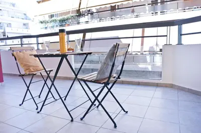 a table and two chairs sitting next to a window at SilkFab Apartments in Athens