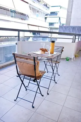 a table and chairs sitting on a roof at SilkFab Apartments in Athens