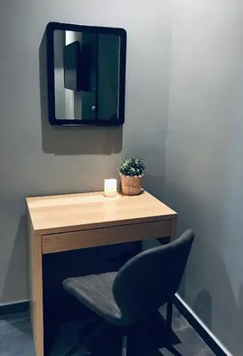 a desk with a chair and a mirror at L apartment in Athens