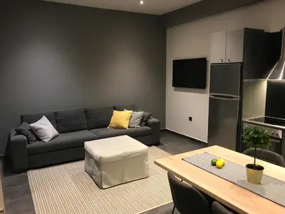 a living room with a couch and a table at L apartment in Athens