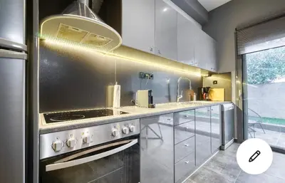 a kitchen with a stainless steel stove top oven at L apartment in Athens