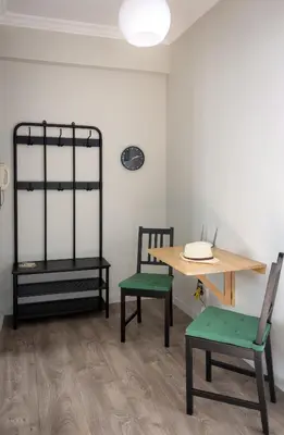 a room with two chairs and a table and a table and a table and bench at Mignon & Teak Apartments in Athens