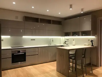 a kitchen with stainless steel appliances and a counter with stools at Luxury & Stylish Family Apartment in Athens