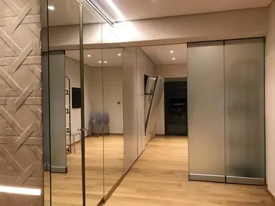 a hallway with glass doors in a building at Luxury & Stylish Family Apartment in Athens