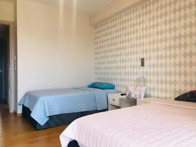 a bedroom with two beds and a wall with two at Luxury & Stylish Family Apartment in Athens