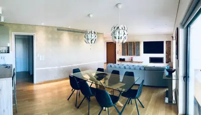 a dining room and kitchen with a glass table and chairs at Luxury & Stylish Family Apartment in Athens