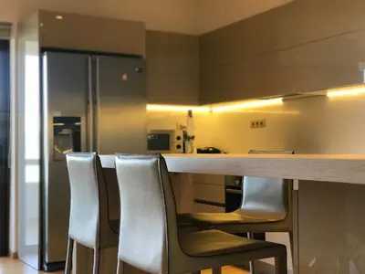a kitchen with a counter with chairs around it at Luxury & Stylish Family Apartment in Athens