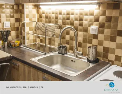a kitchen sink with a faucet on a counter at Denaxas Apartments in the heart of Athens in Athens