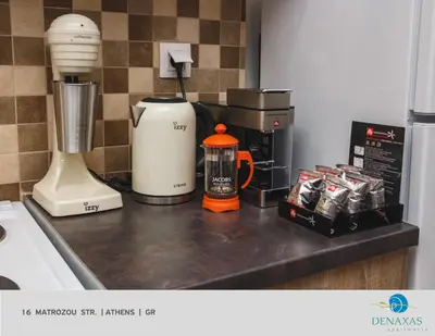 a kitchen counter with a blender and a coffee maker at Denaxas Apartments in the heart of Athens in Athens