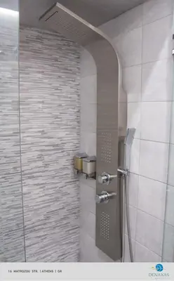 a shower with a glass door in a bathroom at Denaxas Apartments in the heart of Athens in Athens