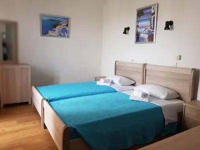 a bedroom with two beds with blue sheets and white pillows at Sparta Team Hotel in Athens